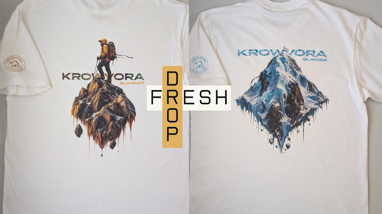 Two white t-shirts shown side by side, displaying the back designs. The left t-shirt features a graphic of a rugged mountain peak with a hiker standing on top and the text behind 'KROWVORA SUMMIT' The right t-shirt features a ice capped mountain peak with a mountaineer climbing to the top and the text behind 'KROWVORA GLACIER'